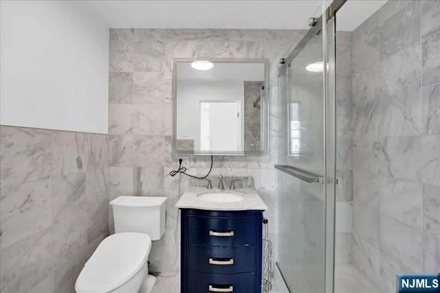 a bathroom with a toilet a sink and mirror