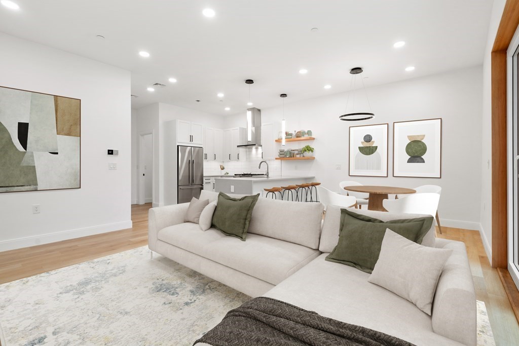 3171 Washington Street, Unit 101 Boston, MA 02130 - Photo 2 of 10 a living room with furniture and a couch