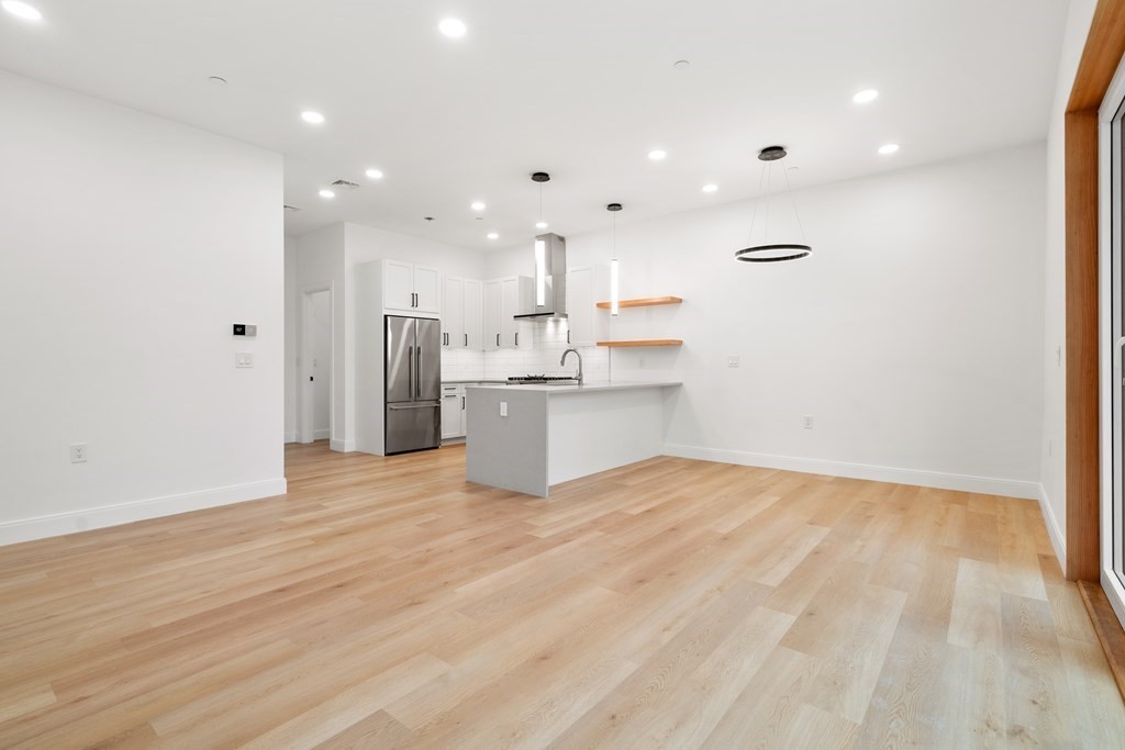 3171 Washington Street, Unit 101 Boston, MA 02130 - Photo 5 of 10 a view of kitchen with wooden floor