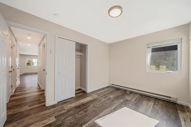 a view of a room with wooden floor and window