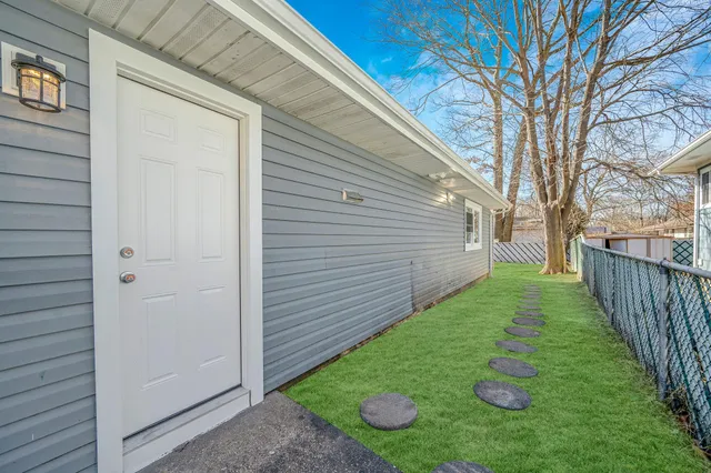 a view of a backyard with wooden fence