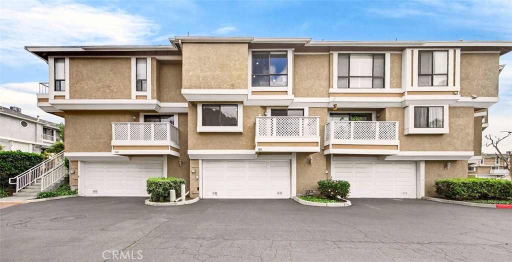 102 South Seneca Circle, Unit CI2 Anaheim, CA 92805 - Photo 1 of 1 a front view of a house with many windows