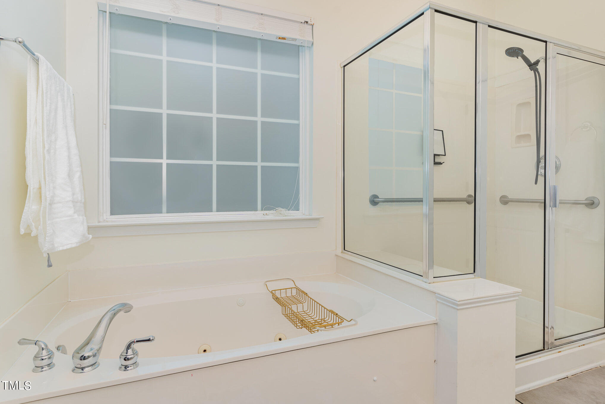 7715 Cloudview Lane Raleigh, NC 27613 - Photo 24 of 36 a bathroom with a tub and a shower