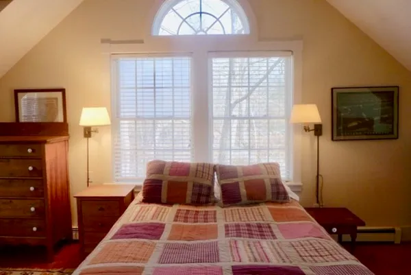 a bath room with a bed and a window