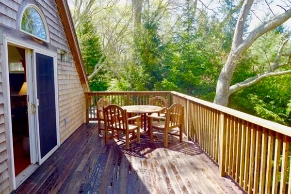 a view of balcony with furniture and wooden deck