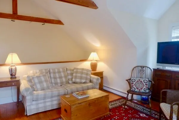 a living room with furniture and a lamp