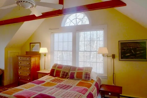 a bedroom with a bed and a window