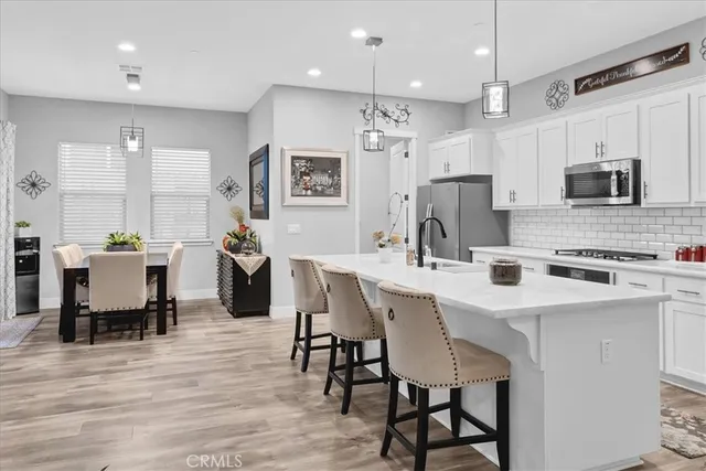 a kitchen with stainless steel appliances a sink stove and cabinets