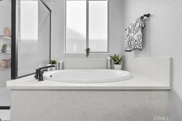 a white toilet sitting next to a white cabinet