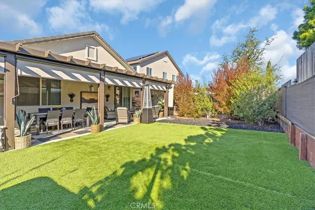 a swimming pool with outdoor seating and yard
