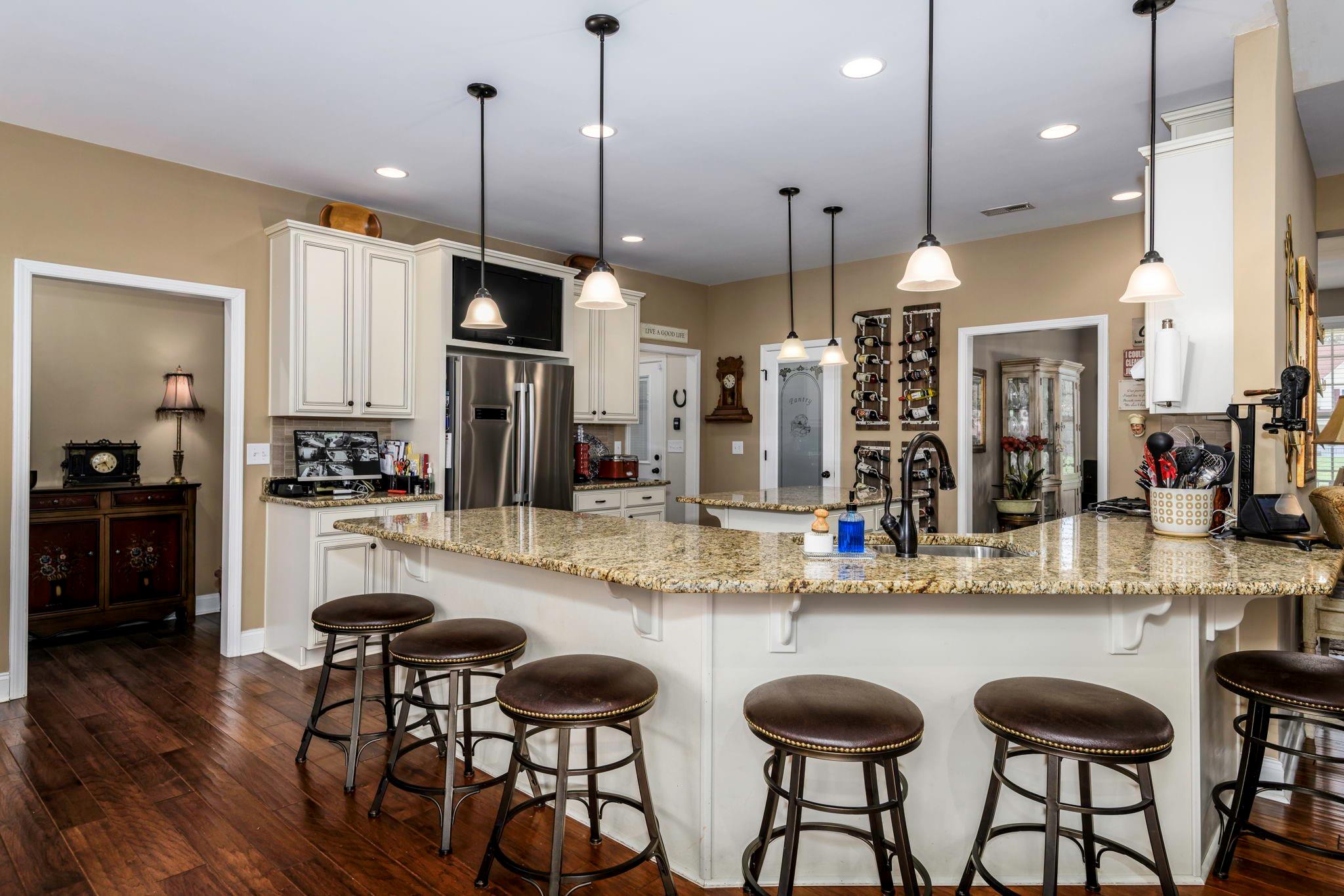 101 Ridge Top Drive Connelly Springs, NC 28612 - Photo 11 of 47 a kitchen with granite countertop a table and chairs