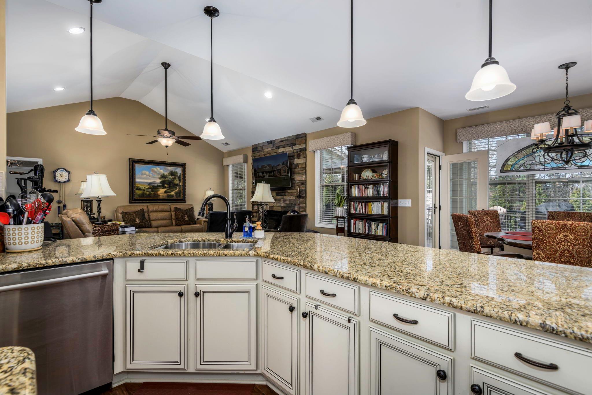 101 Ridge Top Drive Connelly Springs, NC 28612 - Photo 13 of 47 a kitchen with kitchen island a sink and a chandelier