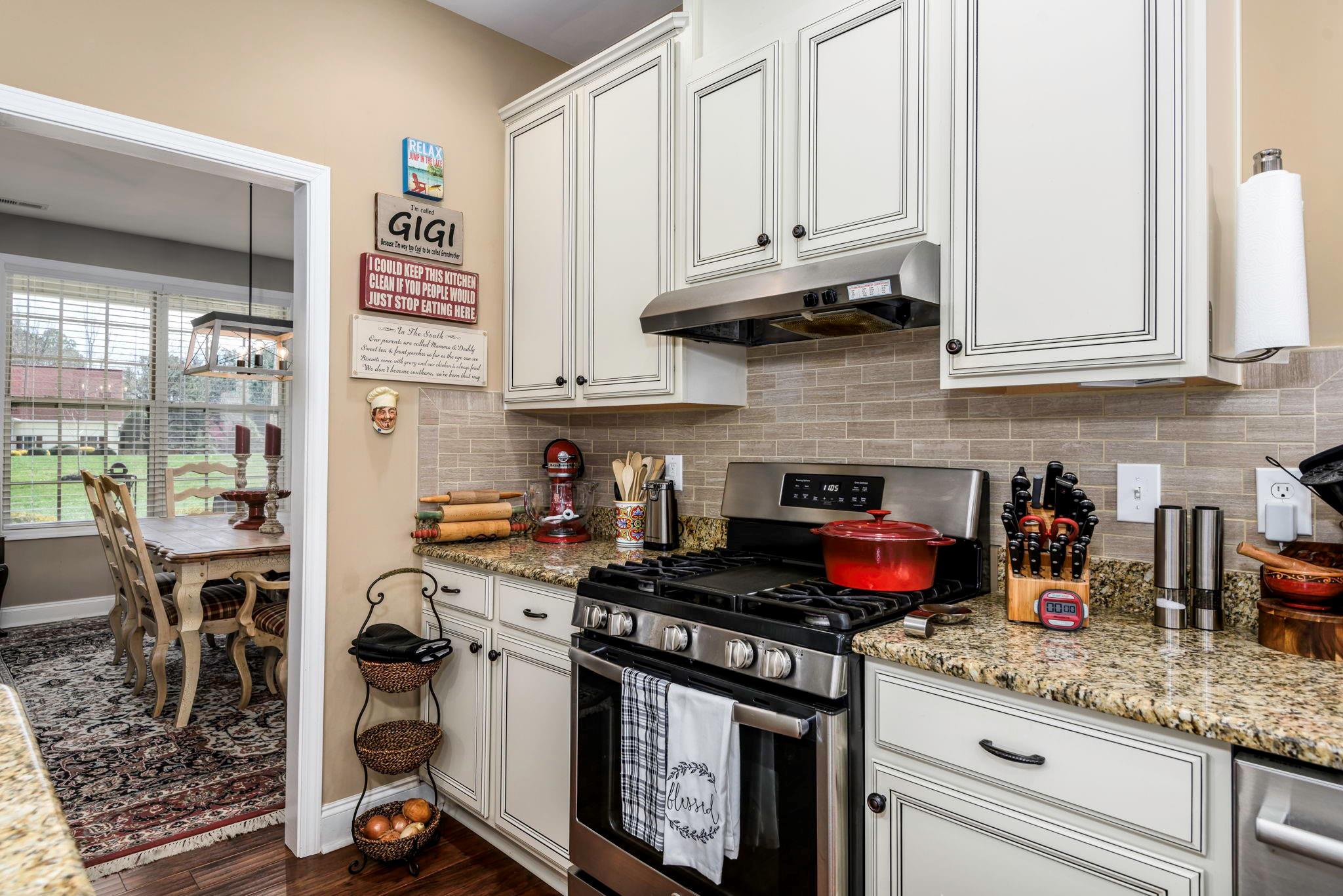 101 Ridge Top Drive Connelly Springs, NC 28612 - Photo 14 of 47 a kitchen with stainless steel appliances granite countertop a stove and cabinets