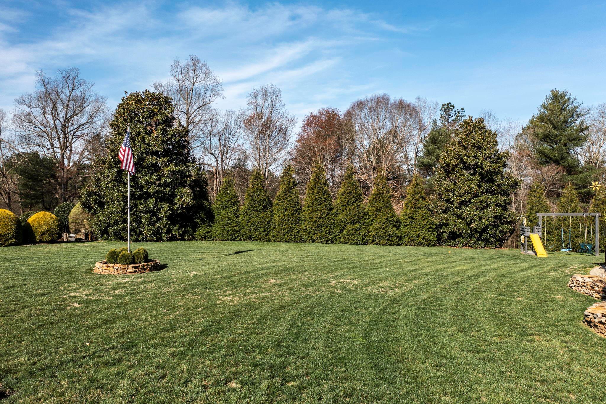 101 Ridge Top Drive Connelly Springs, NC 28612 - Photo 29 of 47 a big yard with lots of green space and house in the back
