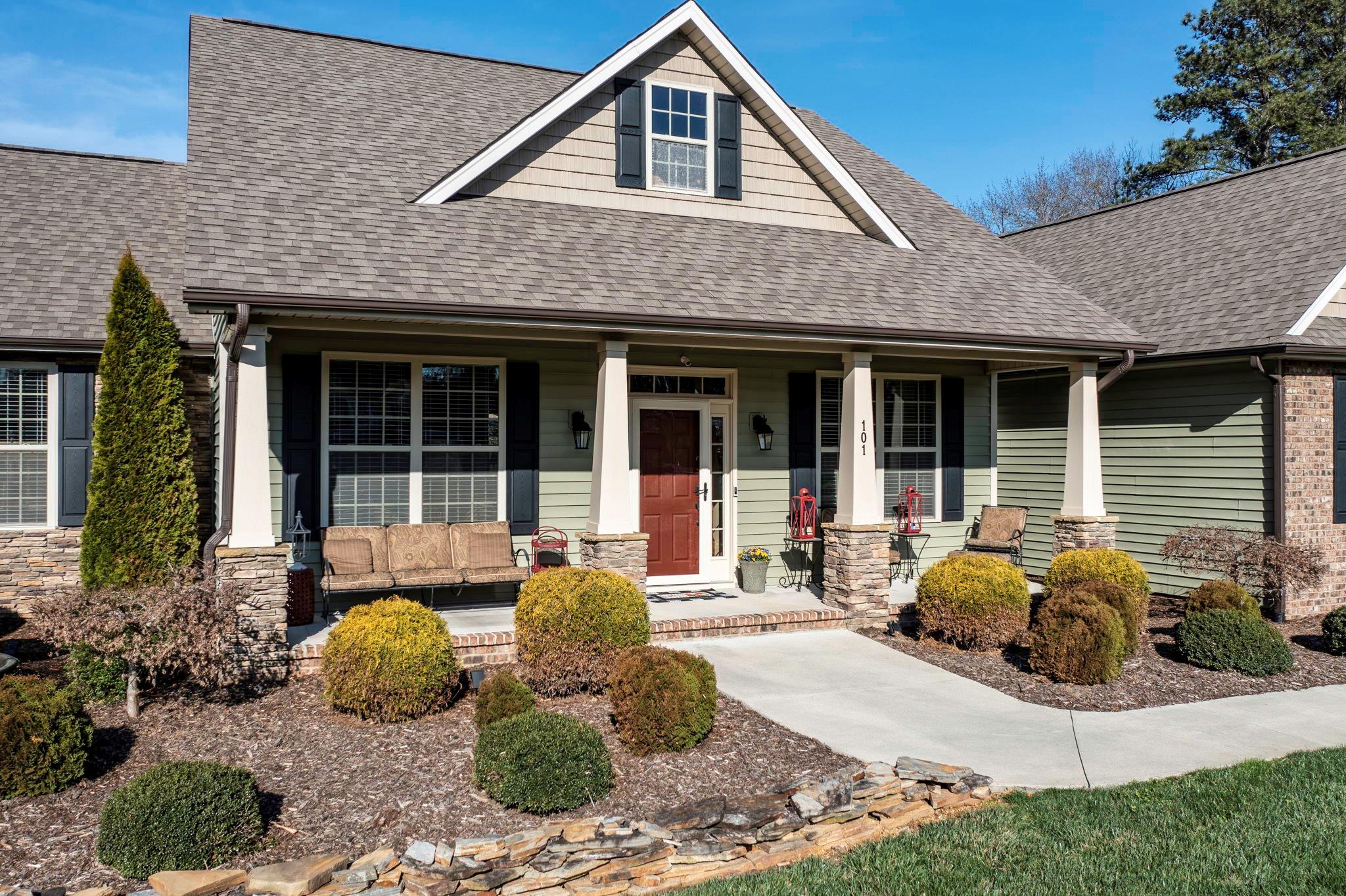 101 Ridge Top Drive Connelly Springs, NC 28612 - Photo 4 of 47 a front view of a house with garden and porch