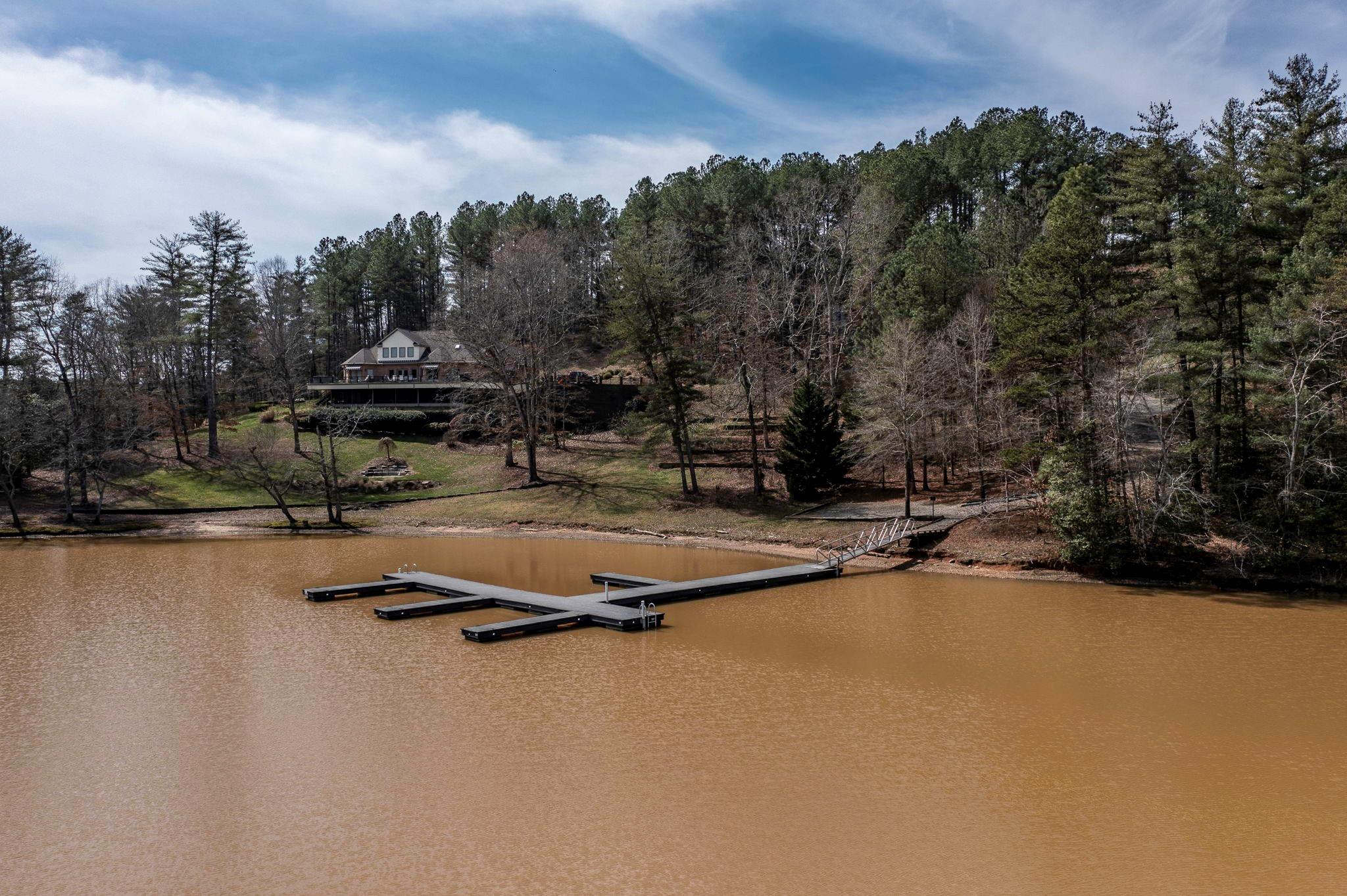 101 Ridge Top Drive Connelly Springs, NC 28612 - Photo 45 of 47 a view of swimming pool with outdoor seating and trees in the background