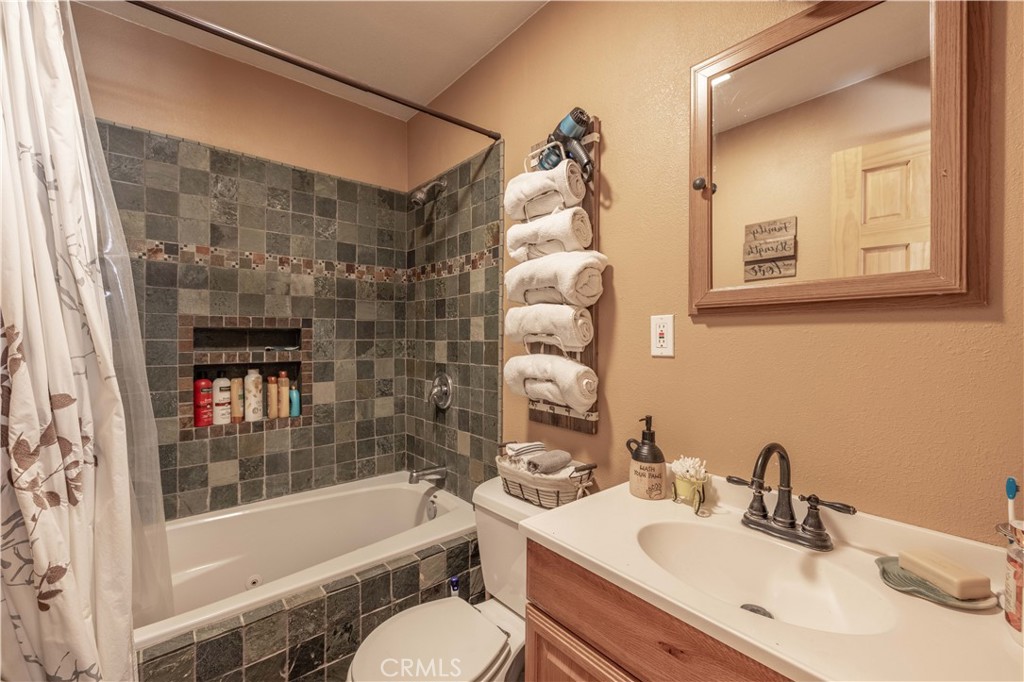 898 B Lane Big Bear City, CA 92314 - Photo 16 of 38 a bathroom with a sink mirror toilet and bathtub
