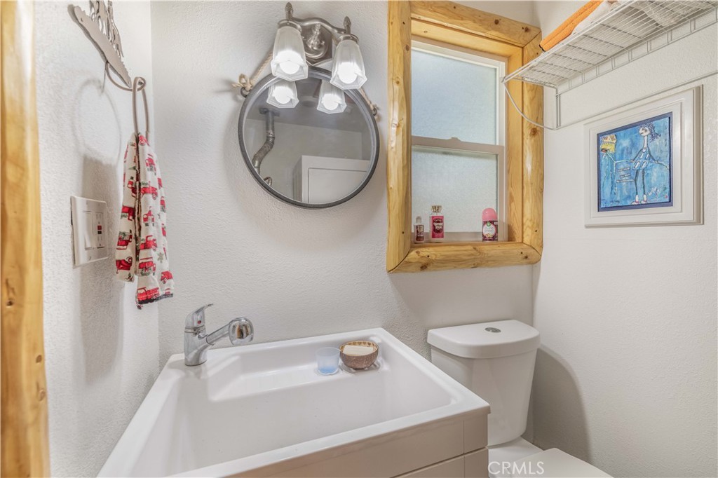 898 B Lane Big Bear City, CA 92314 - Photo 17 of 38 a bathroom with a sink toilet and a mirror