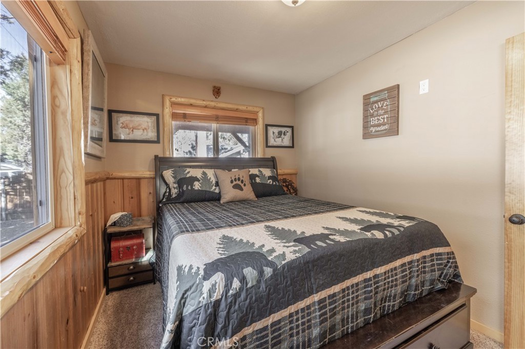 898 B Lane Big Bear City, CA 92314 - Photo 19 of 38 a bedroom with a bed and wooden floor