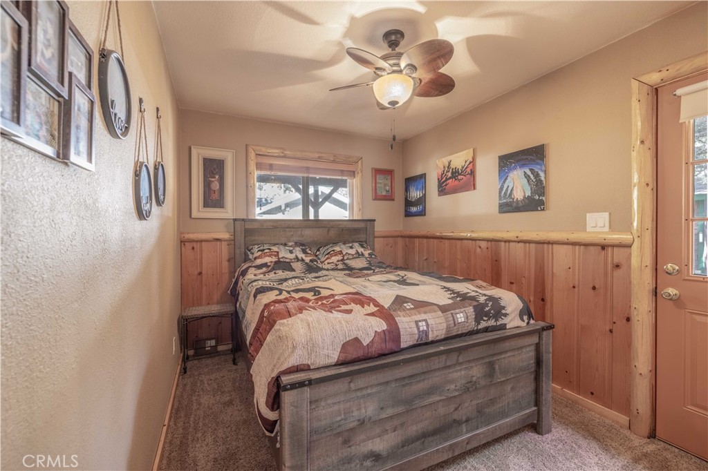 898 B Lane Big Bear City, CA 92314 - Photo 21 of 38 a bedroom with a bed and a chandelier
