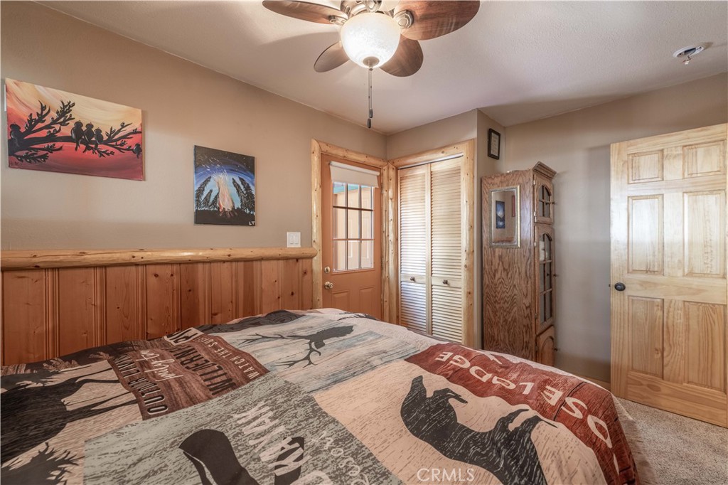 898 B Lane Big Bear City, CA 92314 - Photo 22 of 38 a bedroom with a bed and a chandelier
