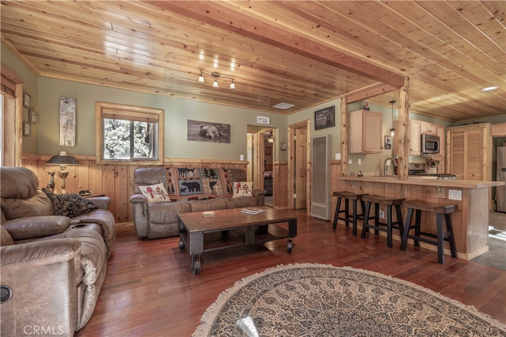 898 B Lane Big Bear City, CA 92314 - Photo 8 of 38 a living room with furniture a rug potted plant and a large window