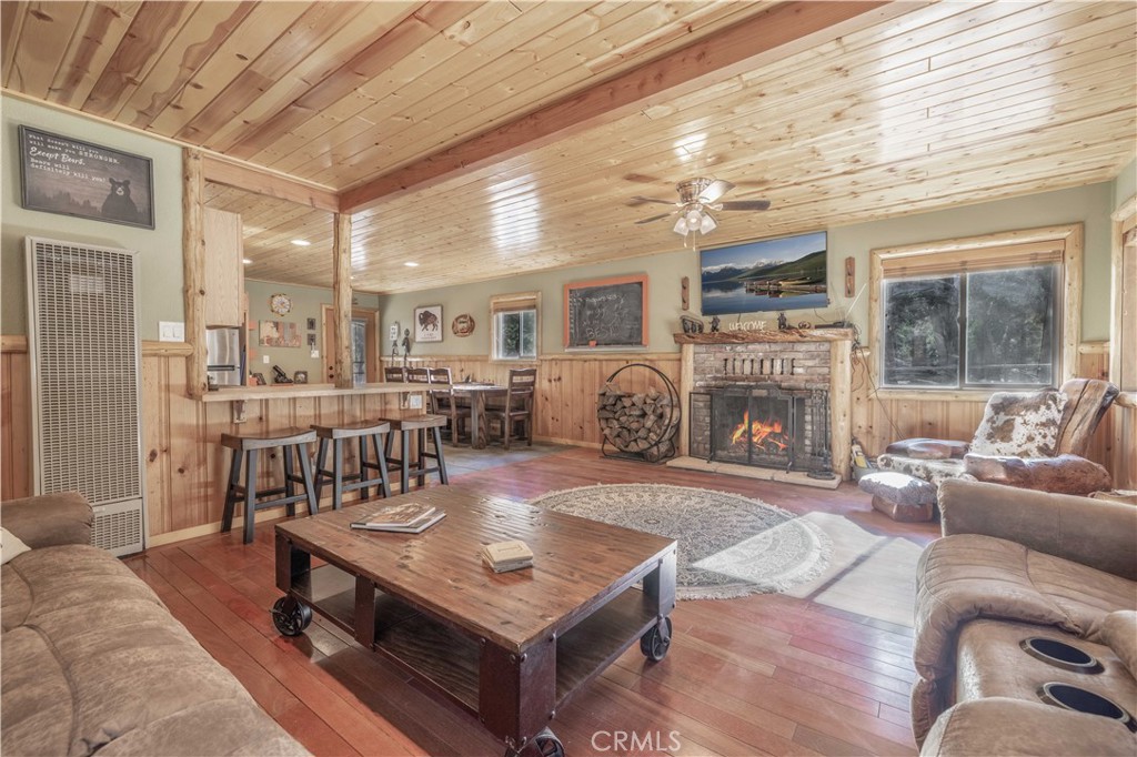 898 B Lane Big Bear City, CA 92314 - Photo 9 of 38 a living room with furniture a fireplace and a table