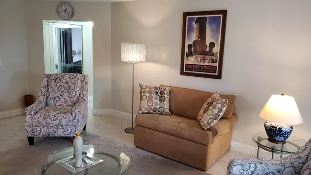 a bedroom with a bed windows and wooden floor
