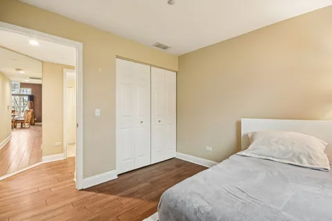 a bedroom with a bed and wooden floor