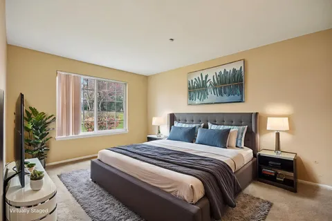 a bedroom with a bed and a couch