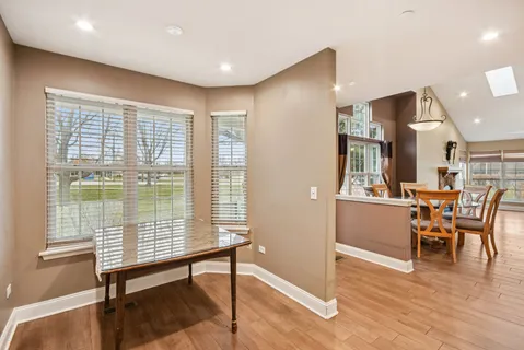 a view of a room with furniture and wooden floor