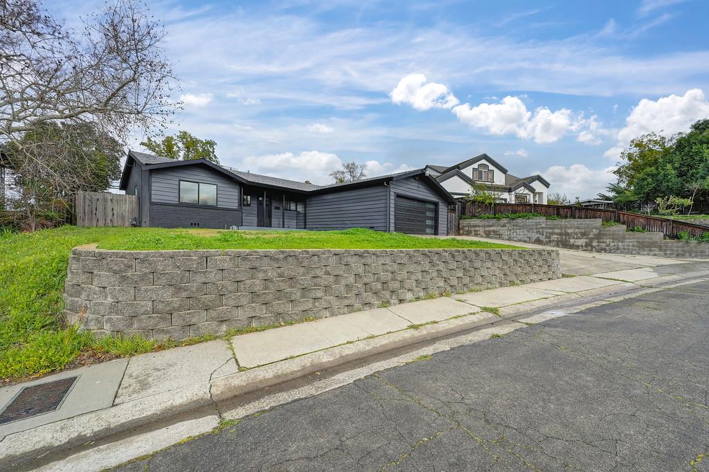 a white house with tall trees in front of it