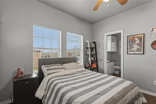 a bedroom with a bed and a dresser next to a window