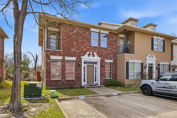 a car parked in front of a brick house