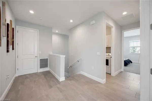 an empty room with closet and mirrors