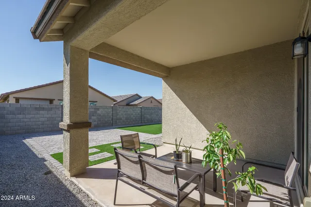 a view of an chairs and table in the patio