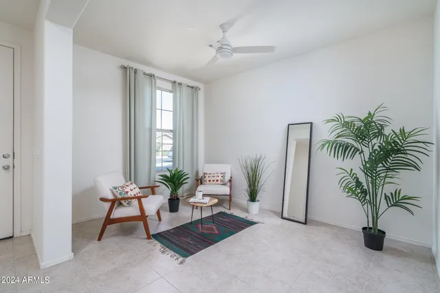 a living room with furniture and a potted plant