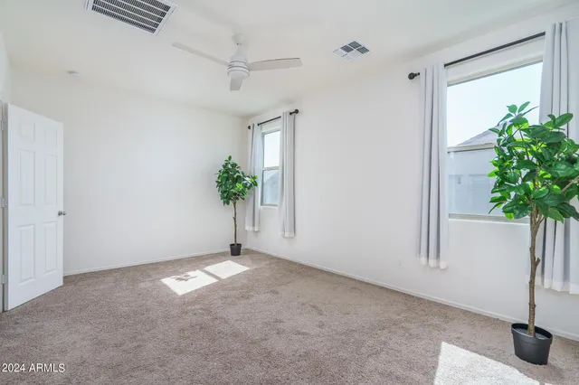 a view of an empty room and a window