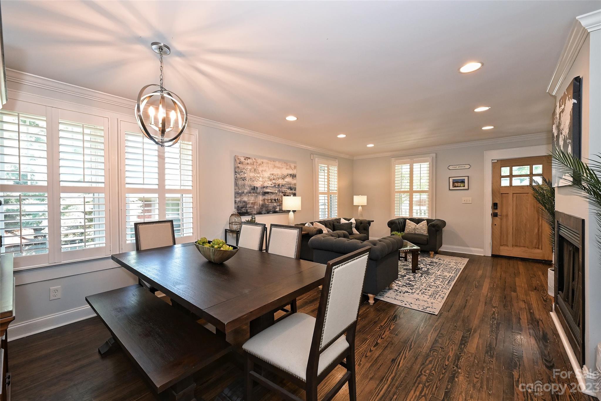 4206 Walker Road Charlotte, NC 28211 - Photo 8 of 40 a living room with furniture a chandelier and a table