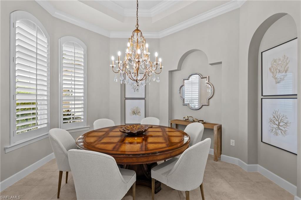 9774 Nickel Ridge Circle Naples, FL 34120 - Photo 12 of 50 a view of a dining room with furniture window and wooden floor