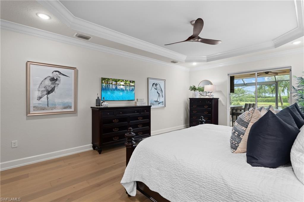 9774 Nickel Ridge Circle Naples, FL 34120 - Photo 14 of 50 a bedroom with a bed and a dresser