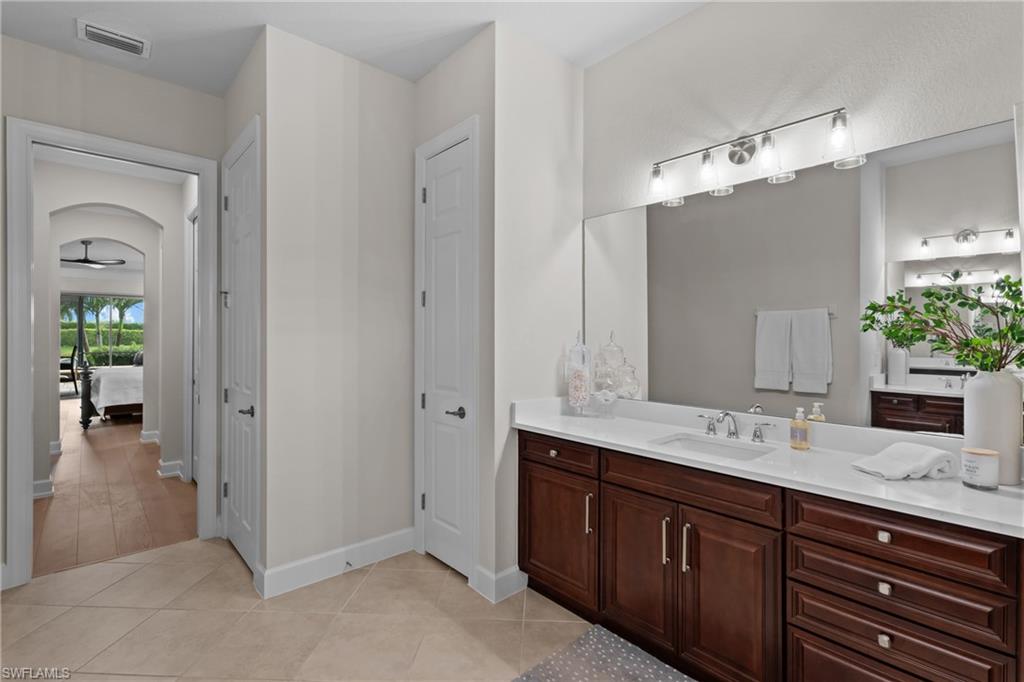 9774 Nickel Ridge Circle Naples, FL 34120 - Photo 17 of 50 a bathroom with a sink double vanity and a mirror