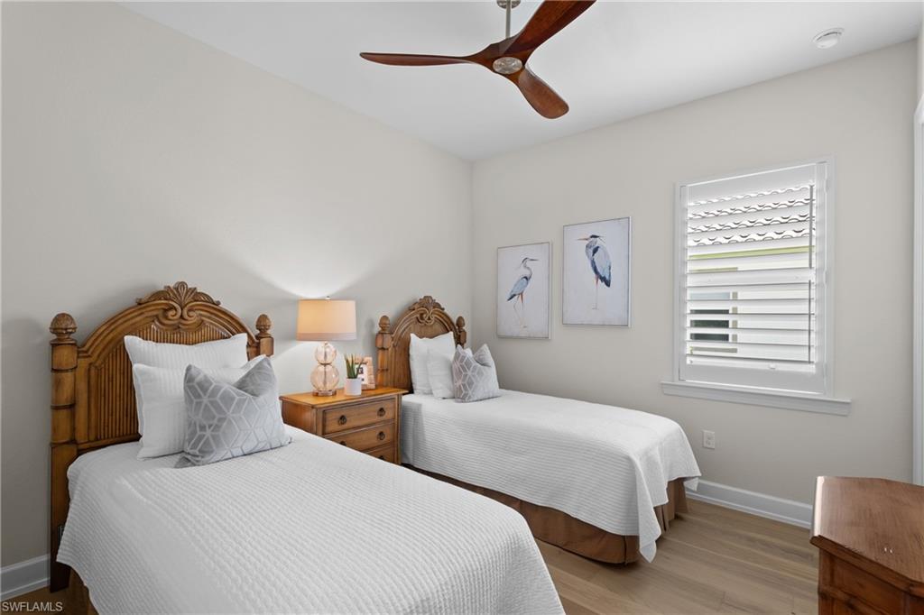 9774 Nickel Ridge Circle Naples, FL 34120 - Photo 18 of 50 a bedroom with two beds and a window