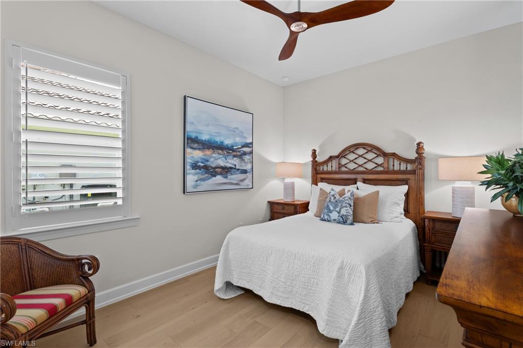 9774 Nickel Ridge Circle Naples, FL 34120 - Photo 19 of 50 a bedroom with a bed a couch and a window