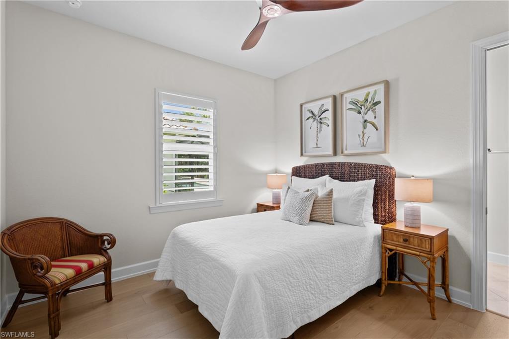 9774 Nickel Ridge Circle Naples, FL 34120 - Photo 21 of 50 a bedroom with a bed and chair