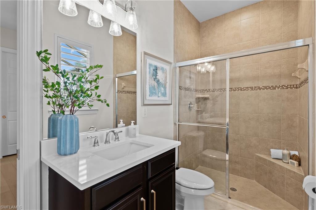 9774 Nickel Ridge Circle Naples, FL 34120 - Photo 22 of 50 a bathroom with a granite countertop sink a toilet and shower