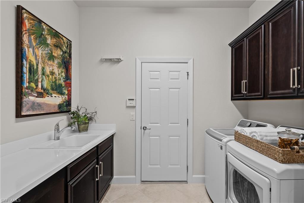 9774 Nickel Ridge Circle Naples, FL 34120 - Photo 24 of 50 a bathroom with a sink and a mirror