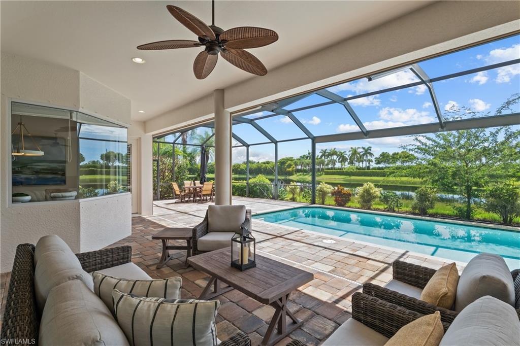 9774 Nickel Ridge Circle Naples, FL 34120 - Photo 25 of 50 a living room with furniture and a floor to ceiling window