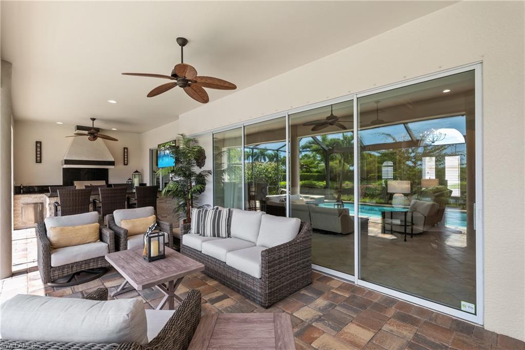 9774 Nickel Ridge Circle Naples, FL 34120 - Photo 27 of 50 a living room with furniture and a floor to ceiling window