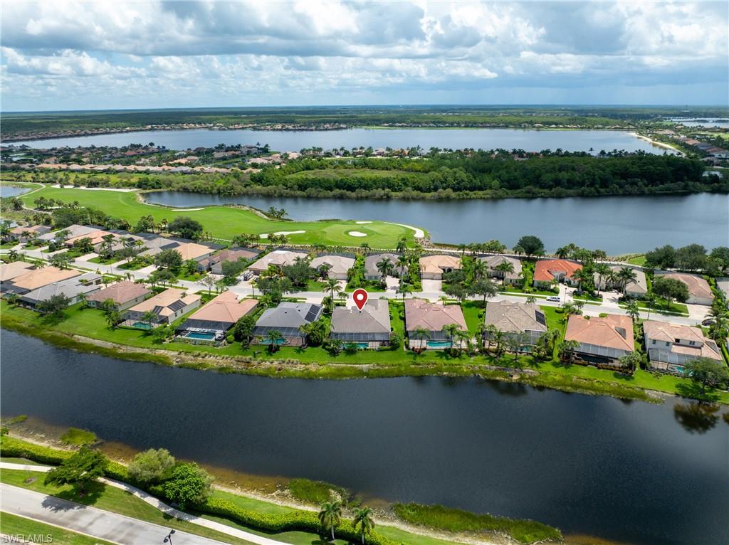 9774 Nickel Ridge Circle Naples, FL 34120 - Photo 34 of 50 a view of a lake with a city